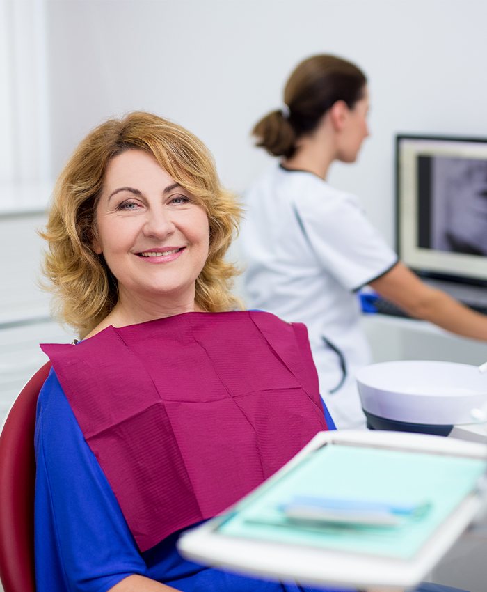 Woman smiling during sleep apnea oral appliance fitting appointment