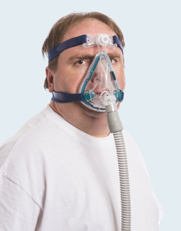 Frustrated man wearing bulky C PAP appliance