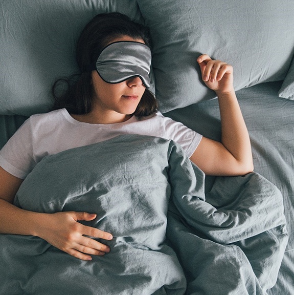 Sleeping woman wearing an eye mask