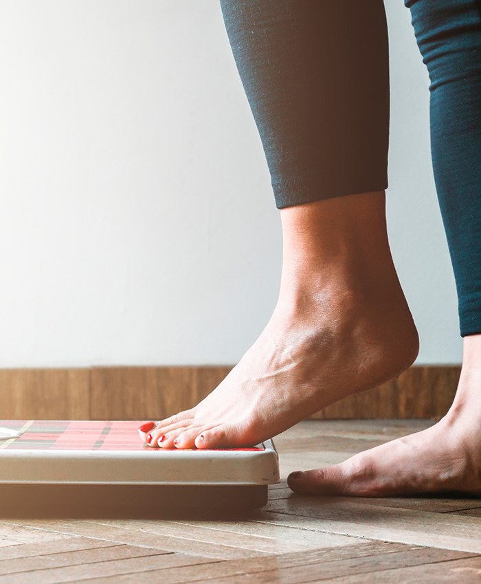 Person stepping onto scale